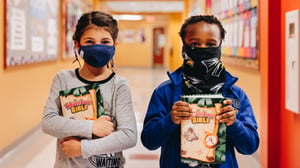 First graders in masks with bibles