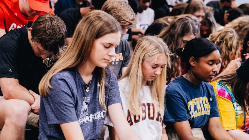 Senior College Day students pray