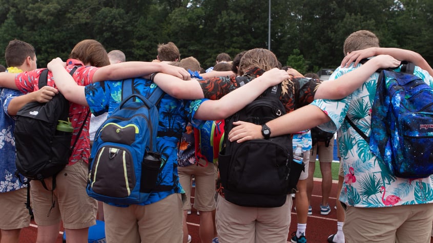 senior boys praying