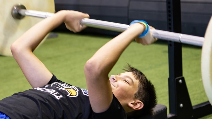 student lifting weights